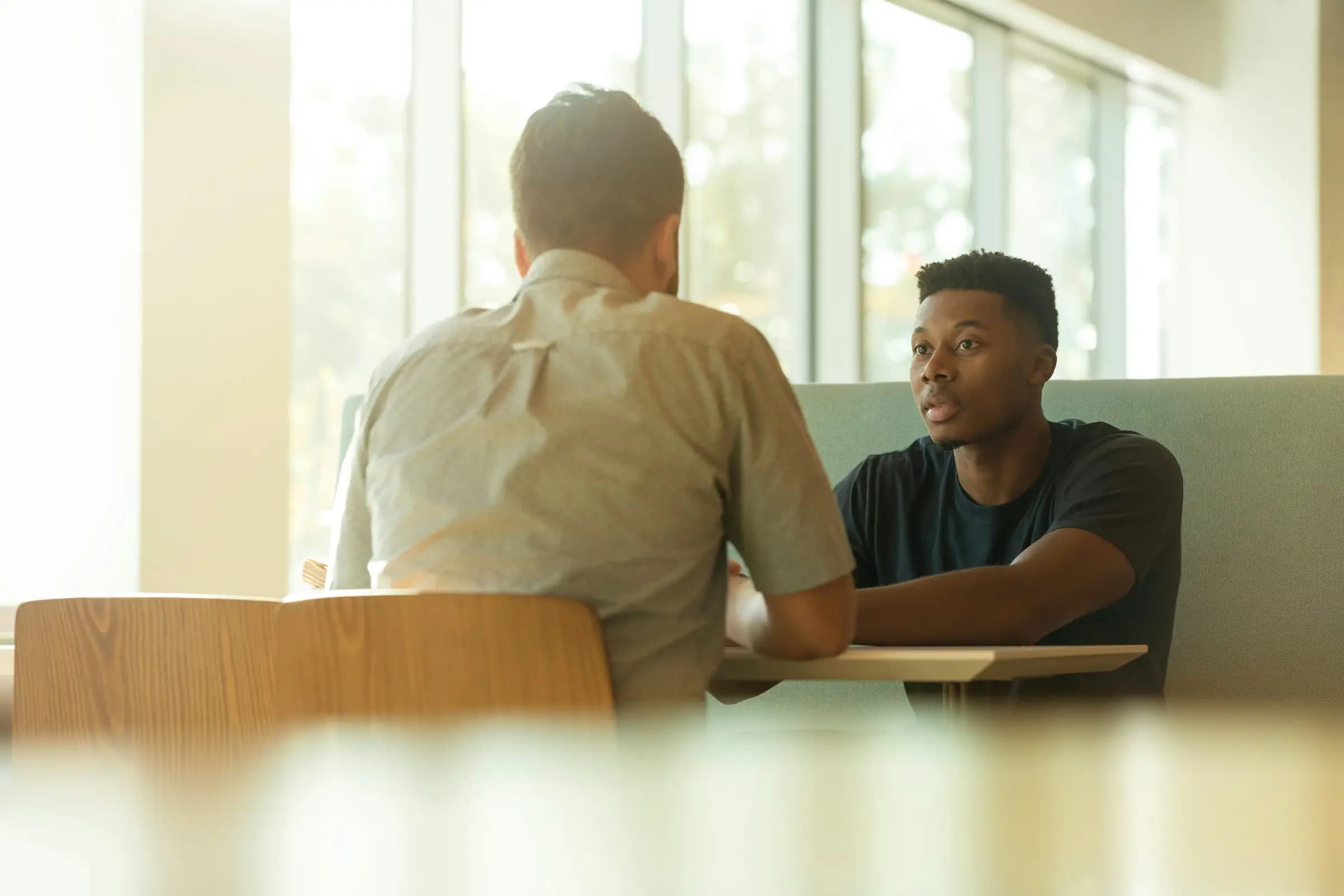 A recruiter interviewing a job candidate across a table