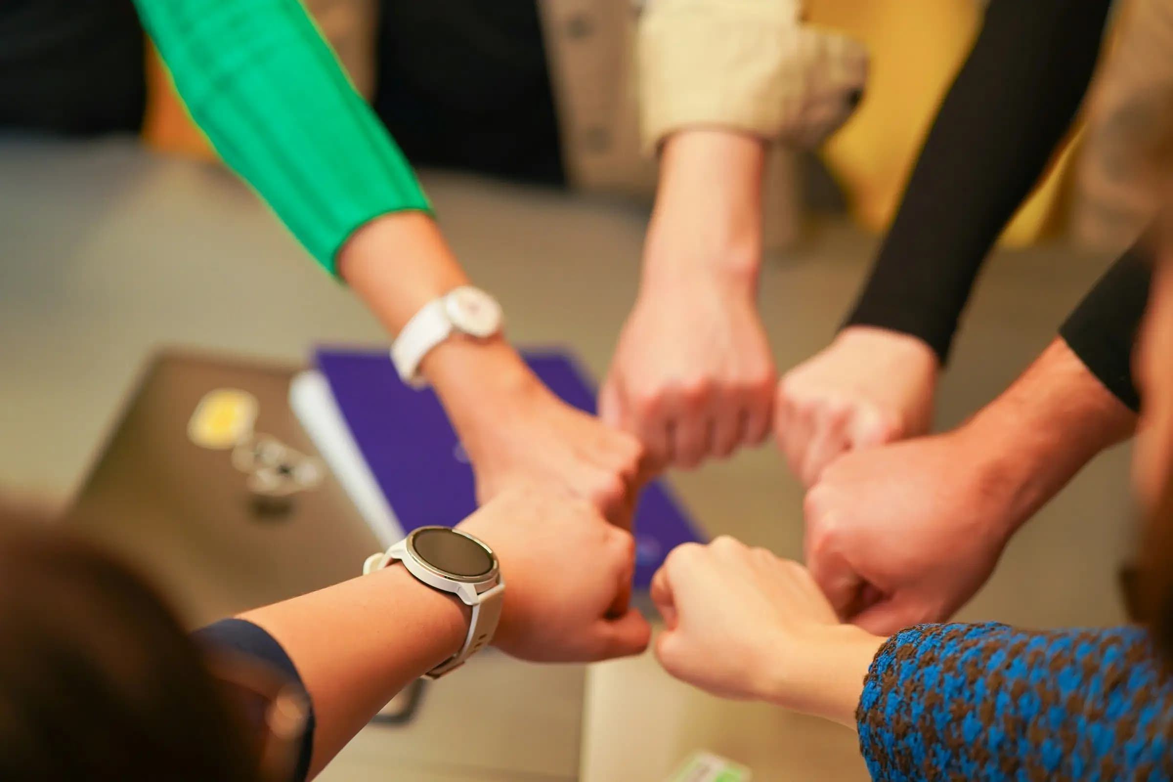 A team joining hands in a circle, one HR partner for every need